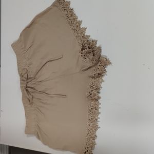 NWOT- ambiance apparel tan shorts with lace bottom. Size Large, Juniors.